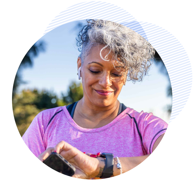 patient using her smart watch and holding her phone