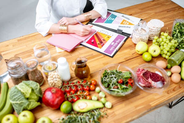 whole foods on the table nutricionist writing something