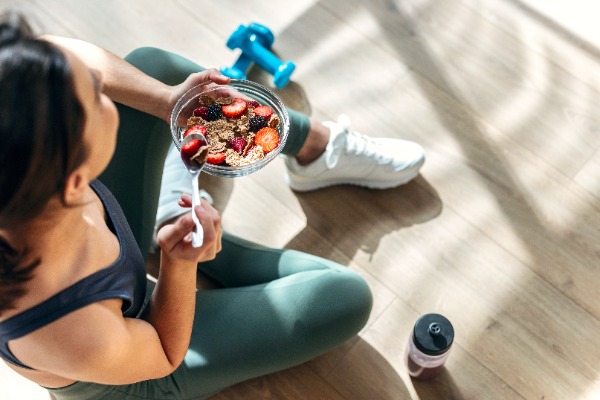 woman in exercise clothes eating healthy