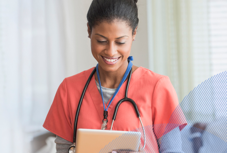 smiling nurse looking at her laptop