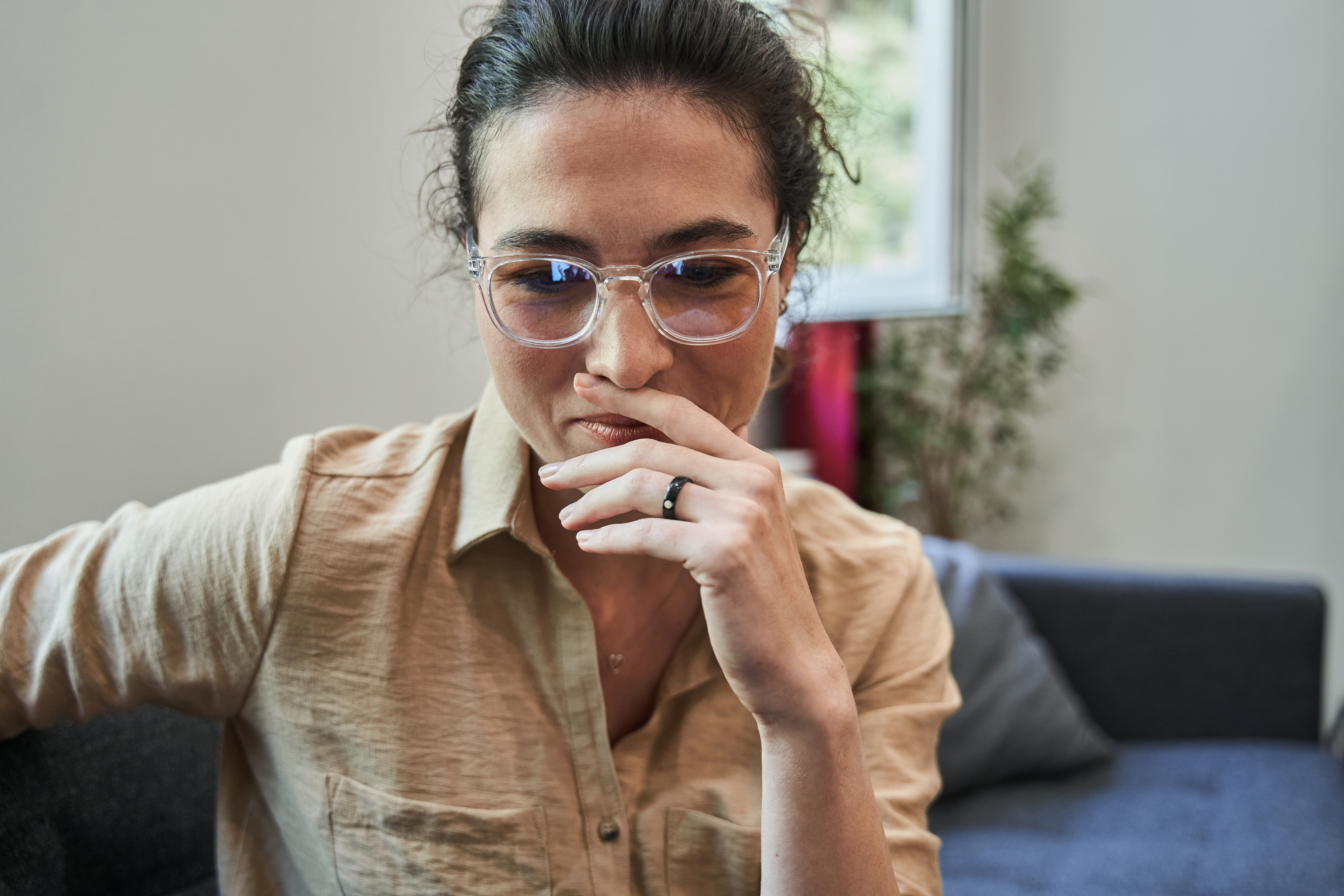 Woman psychiatrist looking at tablet screen while holding video call with her patient